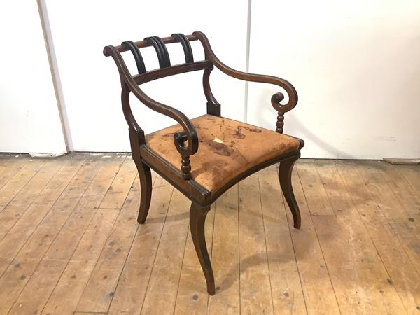 A Scottish Regency mahogany elbow chair, in the Grecian style, the outswept back with ebonised