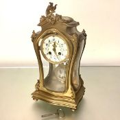 A French four-glass gilt-bronze mantel clock in the Rococo taste, late 19th century, the cartouche