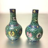 A pair of turquoise ground pottery vases, probably late 19th century, of bottle form, the decoration