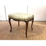 A late 19th century French walnut and parcel-gilt stool, the upholstered seat of serpentine outline,