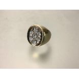 A substantial gentleman's seven stone diamond-set signet ring, the oval plaque with seven largely