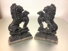 A pair of cast-iron lion rampant door stops, flat back. 38cm