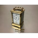 A French 19th century brass-cased alarm carriage clock, by Margaine, Paris, the white enamel dial