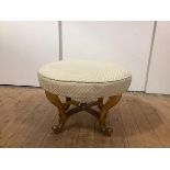 A late 19th century giltwood centre stool, the circular seat upholstered in a cream lattice