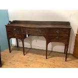 A 19th century mahogany sideboard, the three-quarter gallery above a serpentine front, with