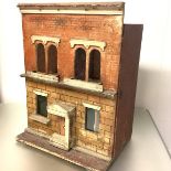 A late 19th century painted wooden doll's house, modelled as a brick two-storey town house, the