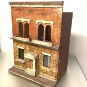 A late 19th century painted wooden doll's house, modelled as a brick two-storey town house, the