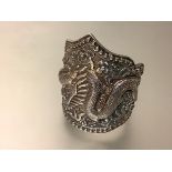 A substantial Chinese silver cuff bangle, chased in high relief with a dragon and flaming pearls,