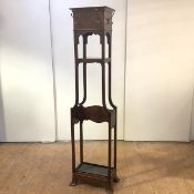 An Edwardian hat and coat stand, the projecting top and frieze applied with brass hooks, above a