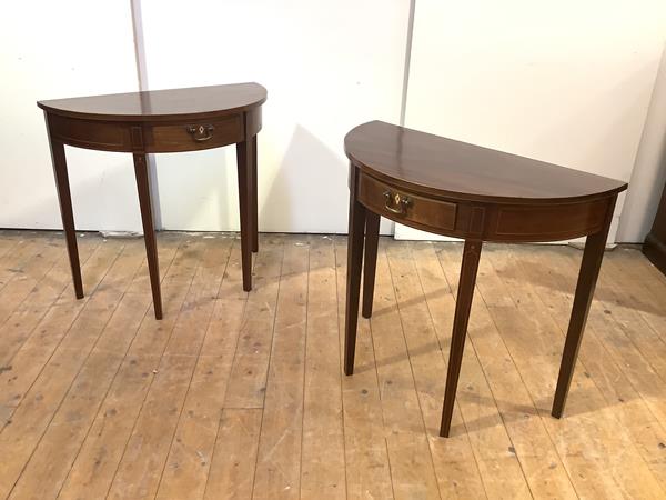 A pair of George III style semi-elliptical tables, 20th century, each with boxwood-lined frieze