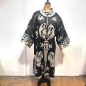 A Chinese embroidered silk coat, with "mandarin" collar and half-length sleeves, with vents to