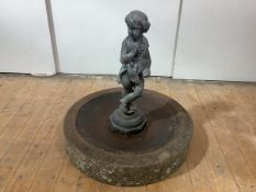 H. Crowther, London, "Autumn" a cast lead garden figure, mounted on a large sandstone mill wheel.