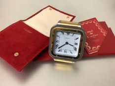 Must de Cartier a Santos bi-colour travelling alarm clock, the square white enamel dial with Roman