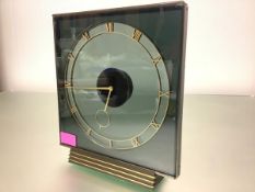 A 1950's mystery clock, with Swiss 17 jewel movement, the square smoked glass case within a