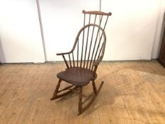 A 19thc cherrywood American Shaker style hoop and comb back rocking chair, on turned supports united