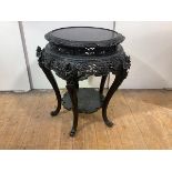 A large Japanese ebonised urn stand, late 19th century, the circular top with pierced border and