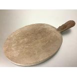 Workshop of Robert (Mouseman) Thompson, an oval oak cheese or bread board, with carved mouse