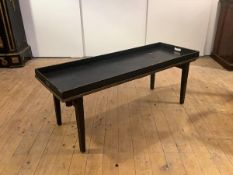 A modern ebonised butler's tray, the solid gallery with a pair of pierced handles, raised on