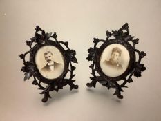 A pair of 19th century carved wooden photograph frames of Black Forest type, each oval aperture