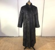 A full length mink coat, 1980's, with shawl collar and tapering sleeves, bearing label to the lining