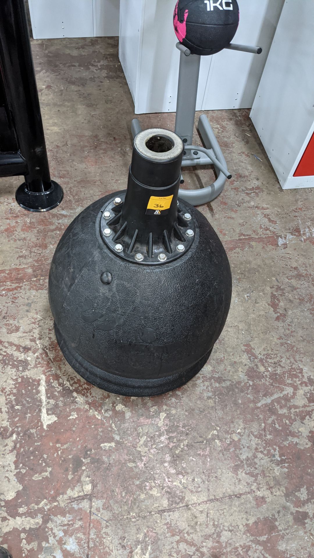 Round weighted base unit used for supporting a pole, assumed to be for use with punching torsos