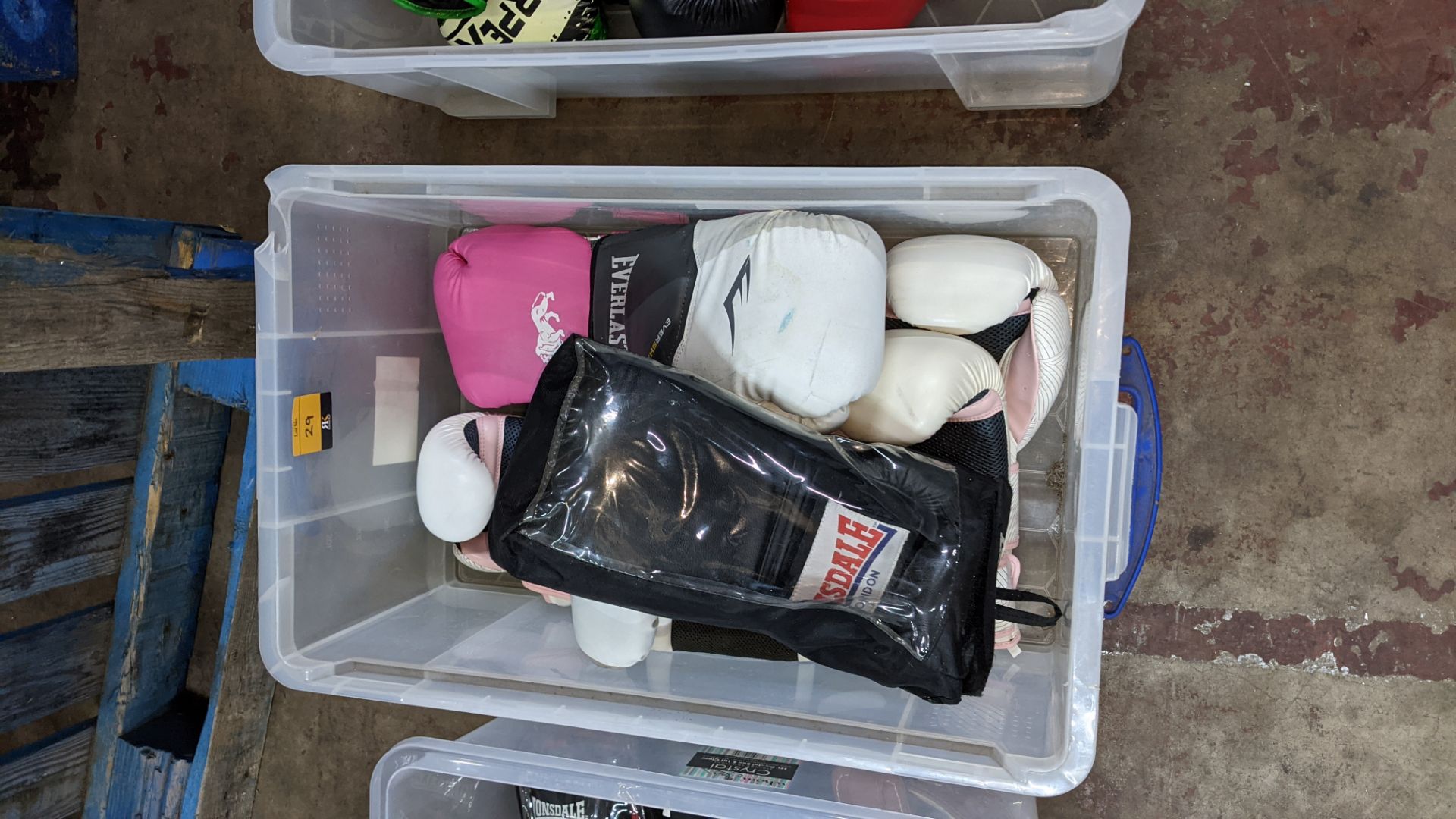 5 assorted pairs of boxing gloves including several that appear to be designed for women with pink d