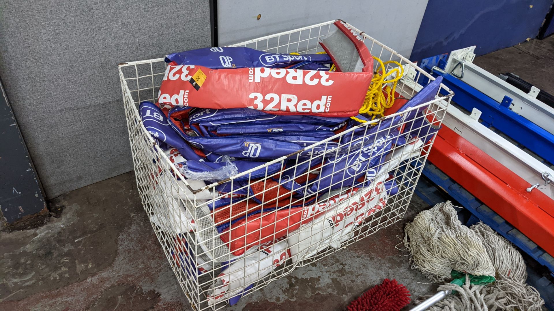 The contents of a cage of boxing ring rope covers, marked 32 red, BT Sport, etc