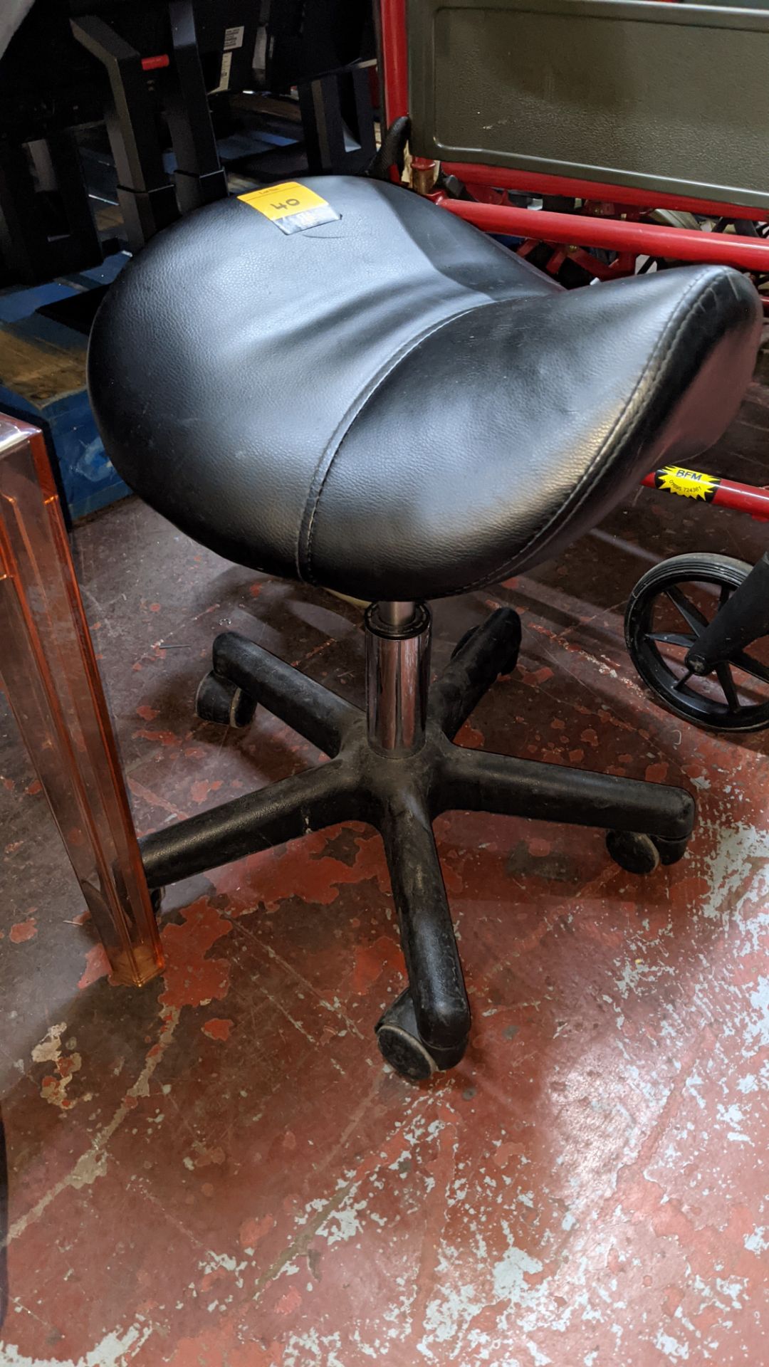 Small stool with saddle shaped seat