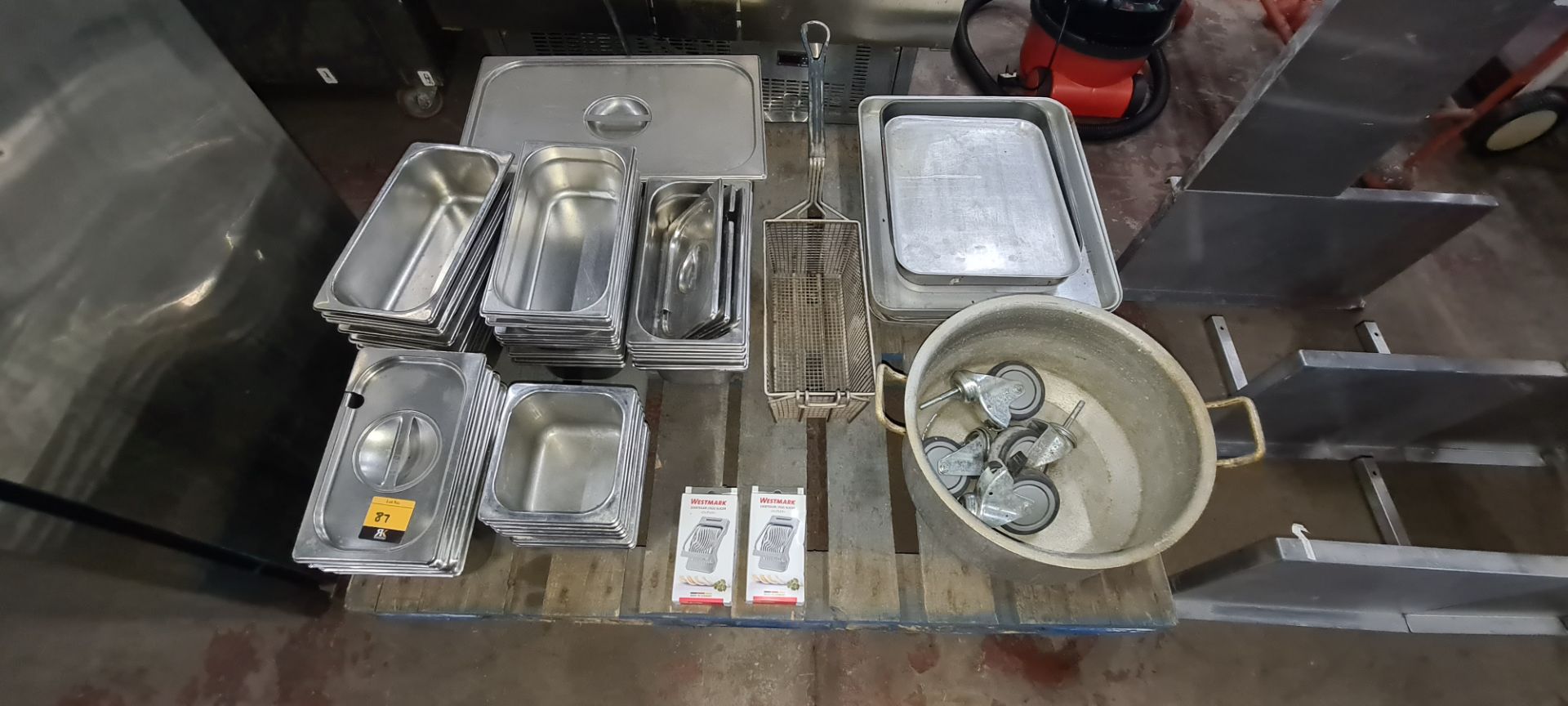 The contents of a pallet of assorted stainless steel dishes, trays & more