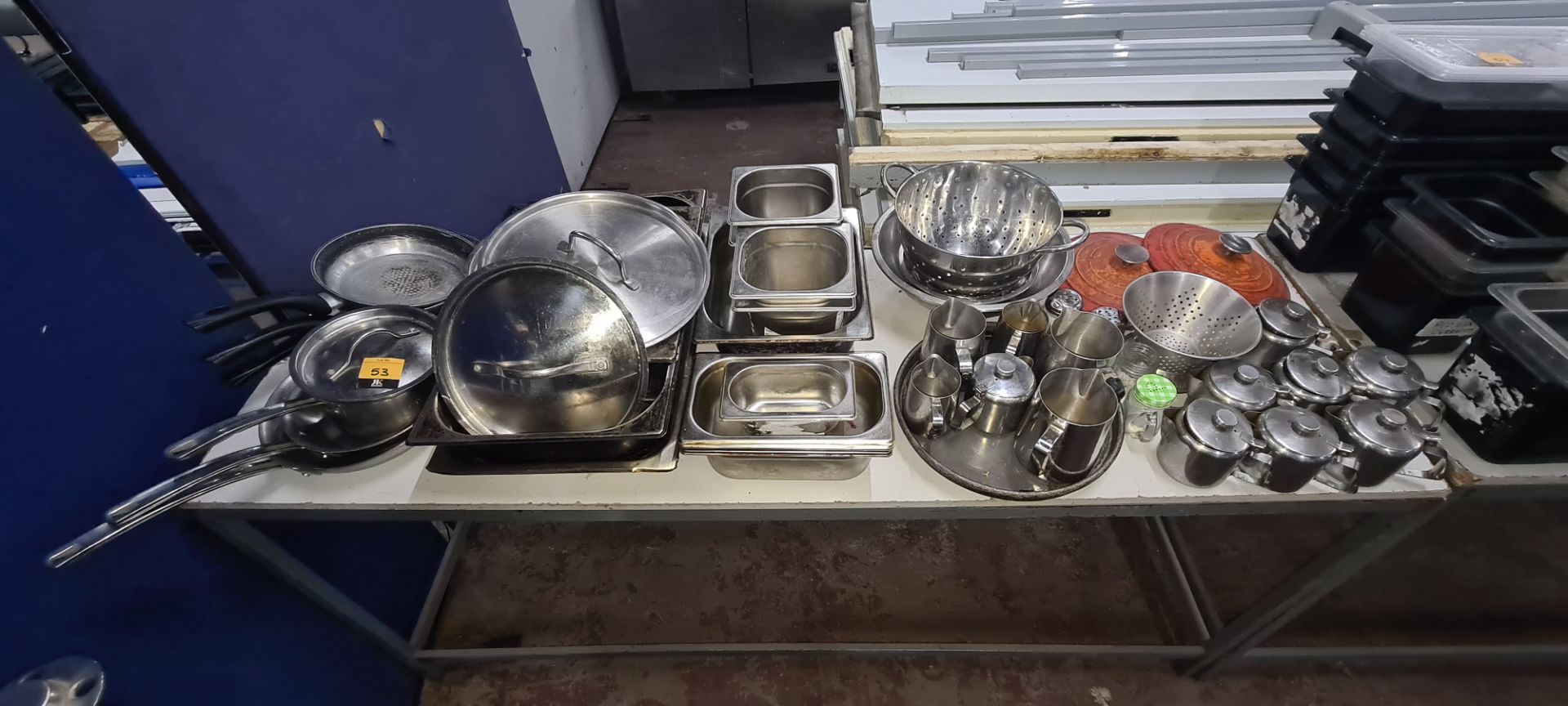 The contents of a table of assorted pots, pans, jugs & other kitchen related items