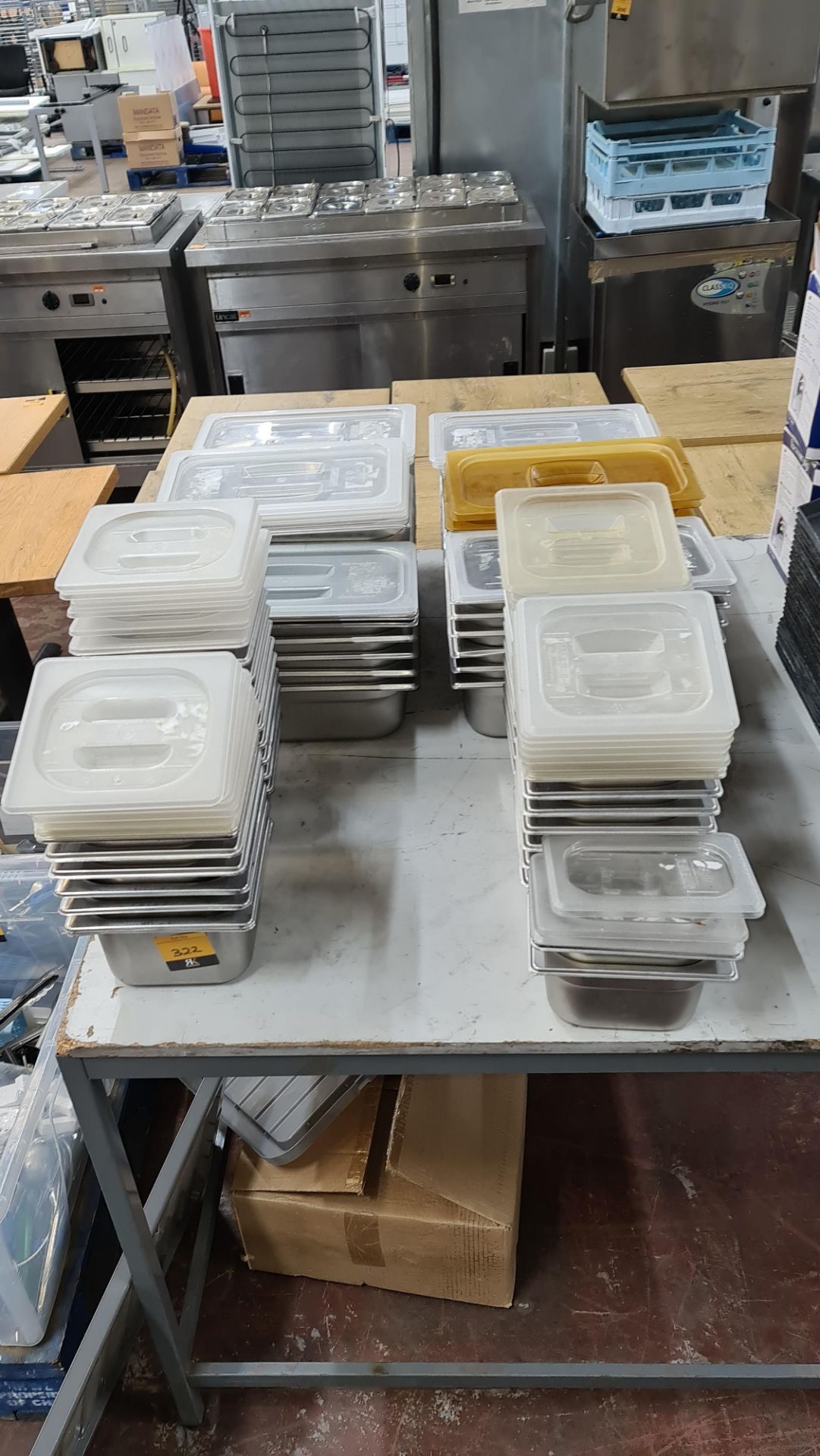 Double row of assorted metal dishes suitable for use in bain maries, refrigerated saladettes, etc