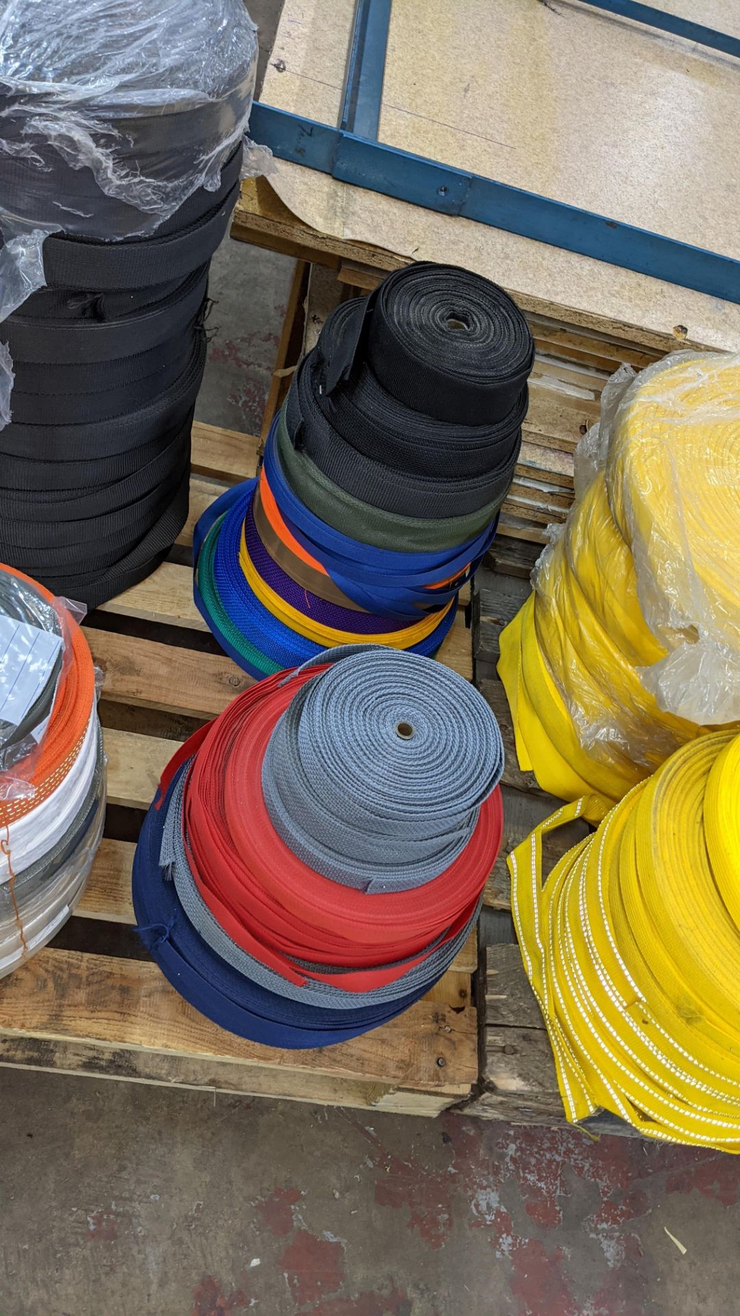 Quantity of reels of what is assumed to be belt fabric, in a variety of colours, in 8 stacks - Image 6 of 7