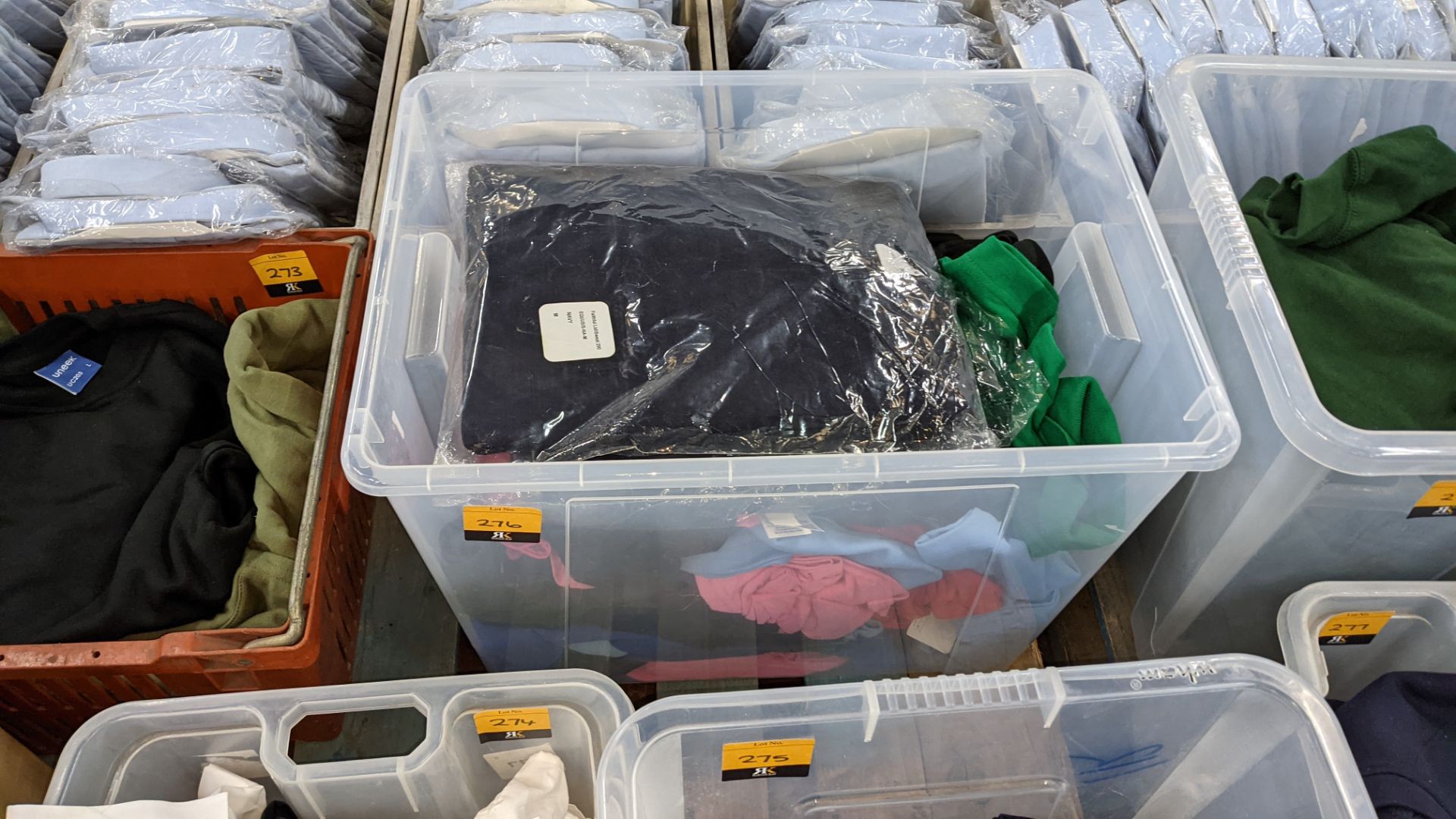 The contents of a crate of assorted garments. NB crate excluded