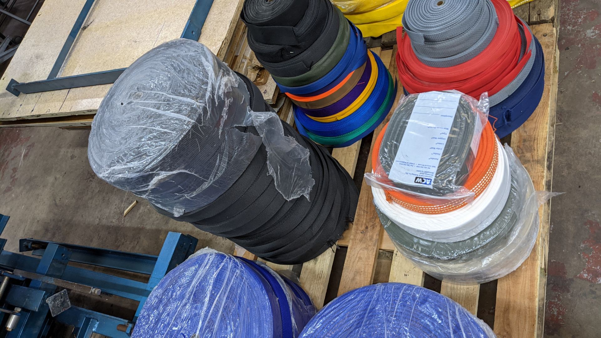 Quantity of reels of what is assumed to be belt fabric, in a variety of colours, in 8 stacks - Image 5 of 7