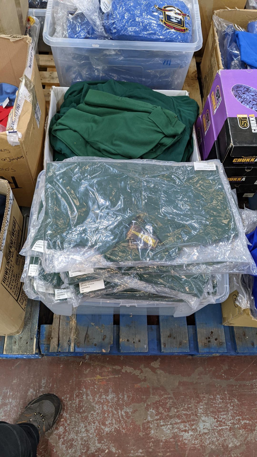 Approx 80 off green polo shirts & sweatshirts - the contents of 2 boxes/crates. NB boxes/crates exc