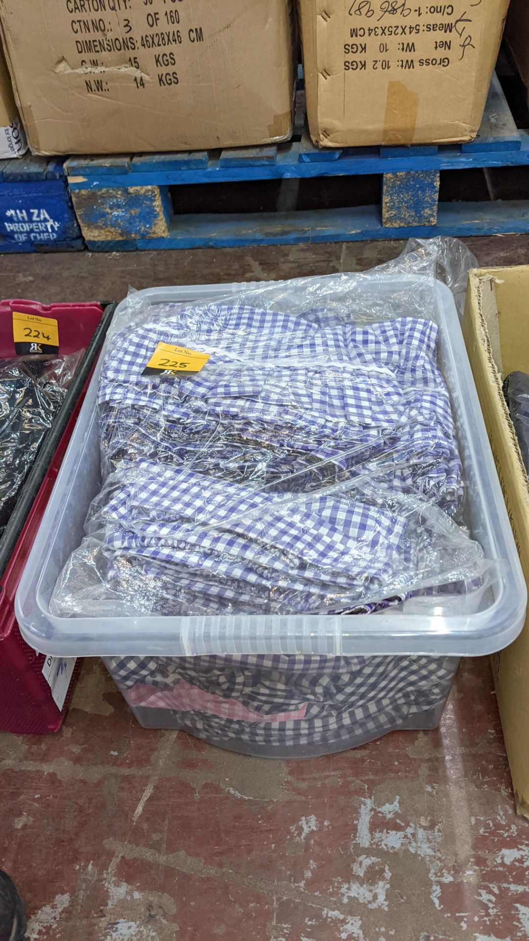 The contents of a crate of children's check skirts. NB crate excluded