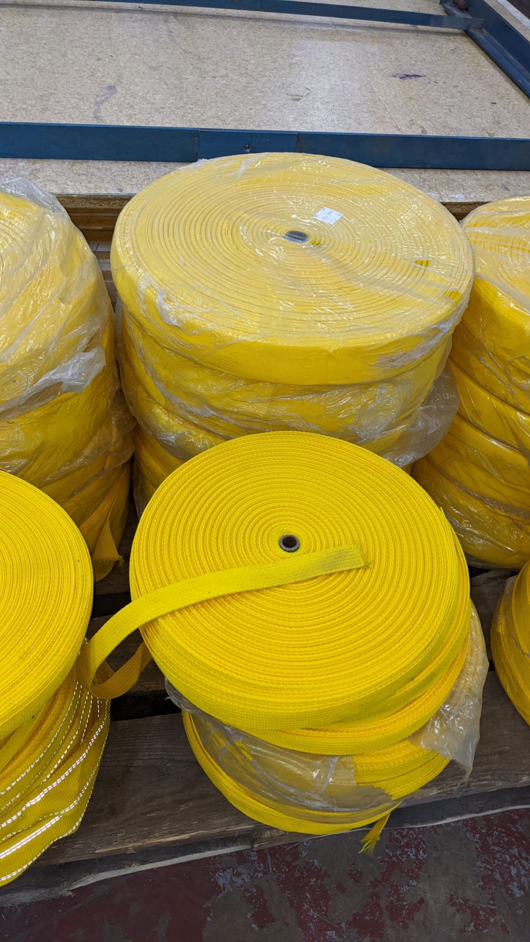 Quantity of reels of what is assumed to be belt fabric, in yellow, in 6 stacks - Image 4 of 5