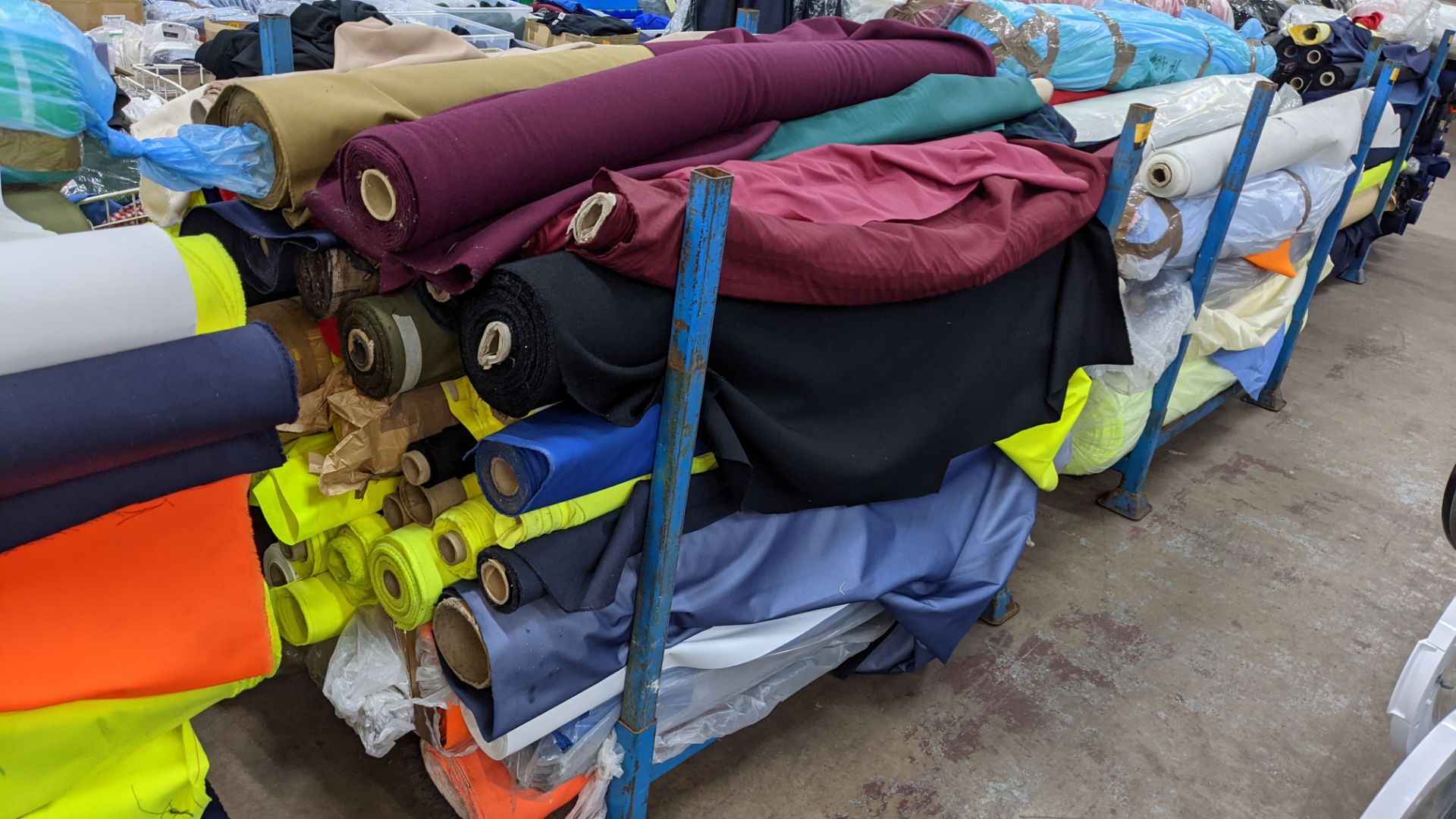 The contents of a large stillage of fabric including quantity of high visibility cloth. Please note