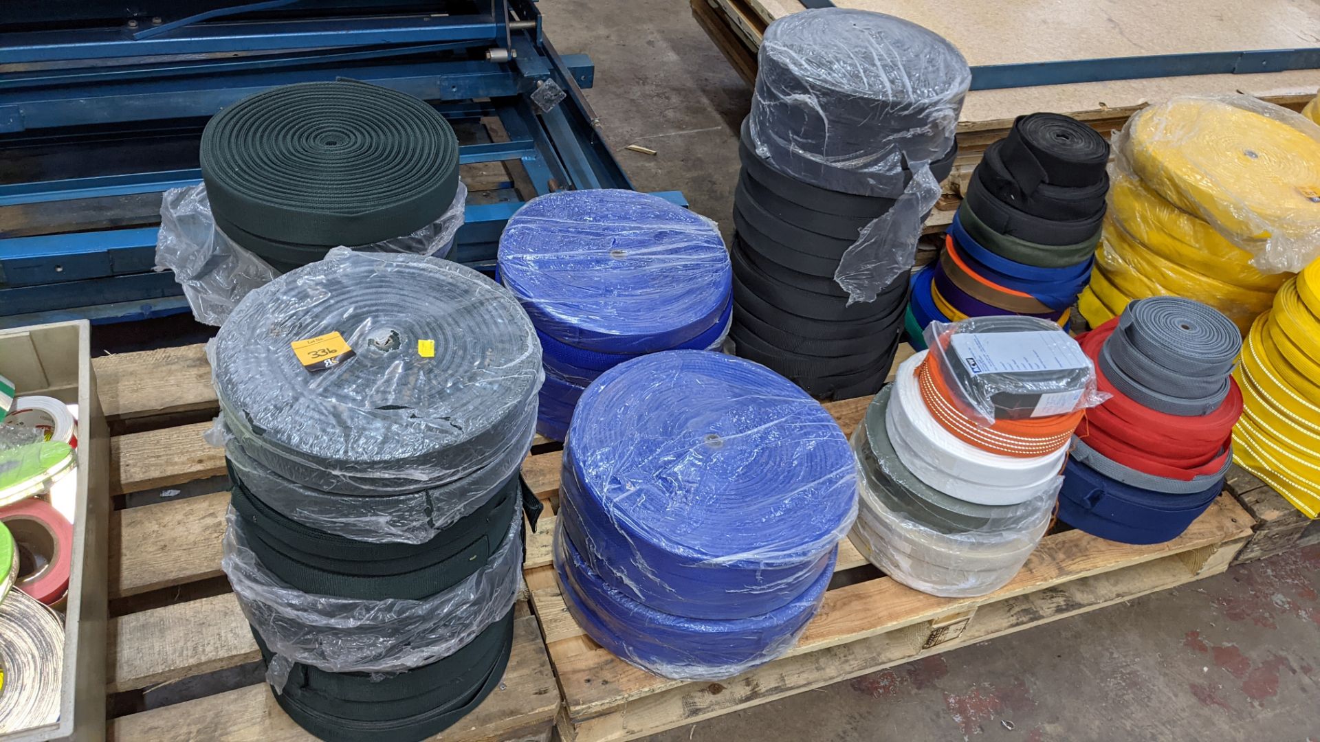 Quantity of reels of what is assumed to be belt fabric, in a variety of colours, in 8 stacks - Image 2 of 7