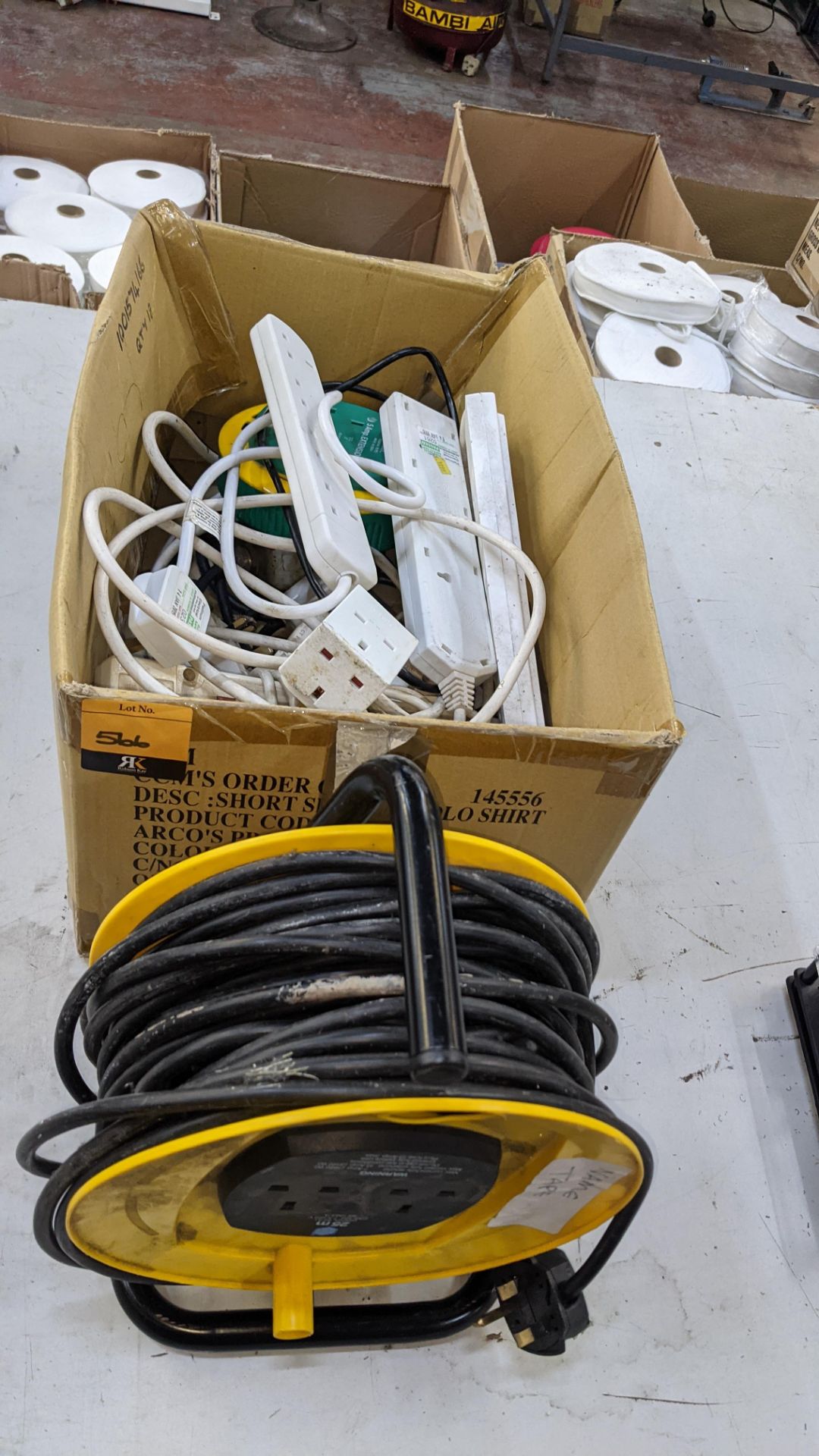 Box of electrical extension cables plus reel of extension cable as pictured in front of the box