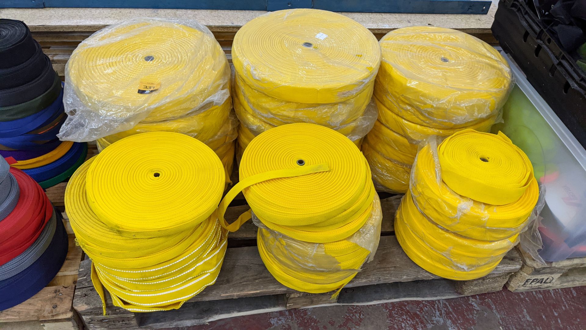 Quantity of reels of what is assumed to be belt fabric, in yellow, in 6 stacks - Image 2 of 5
