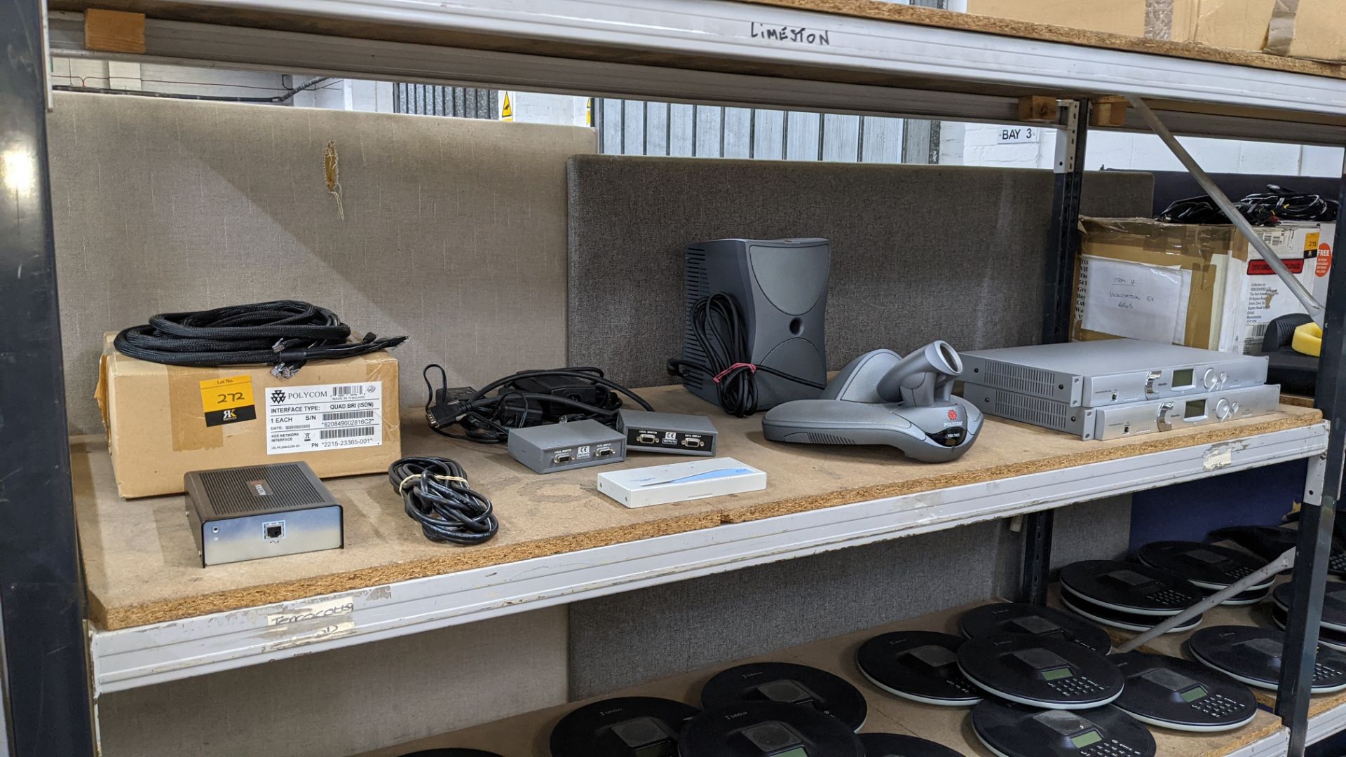 Contents of a shelf of assorted video conferencing equipment by Polycom & others, including ClearOne