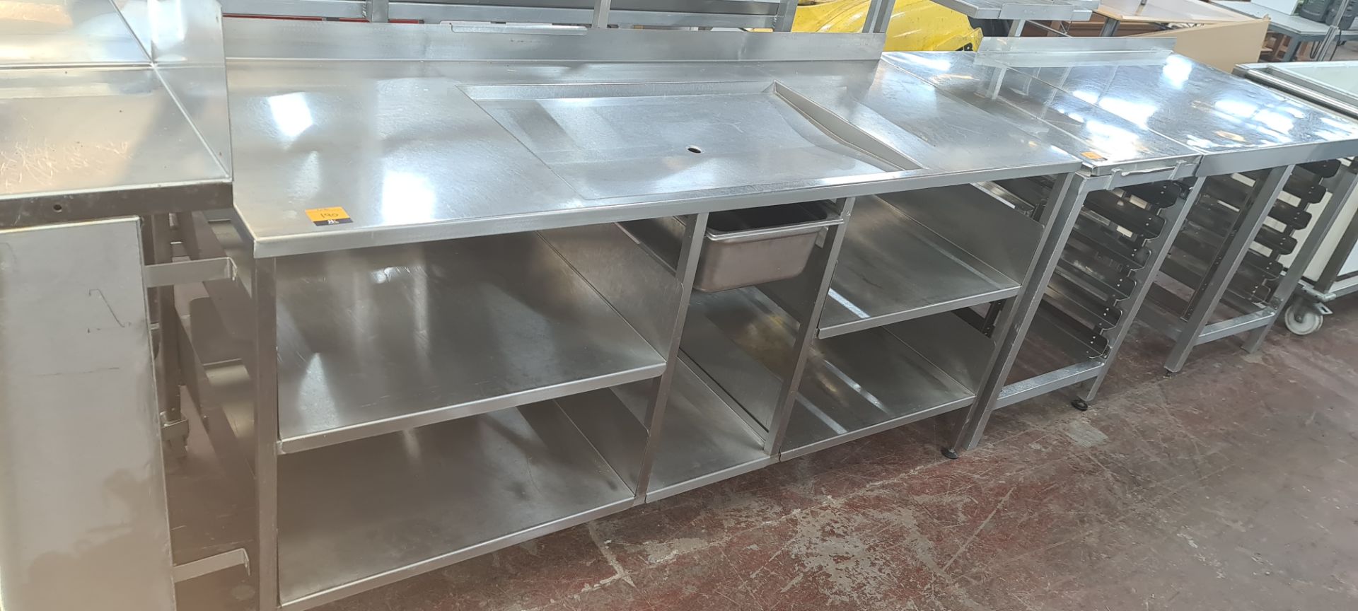 Large stainless steel multi-tier table with draining section