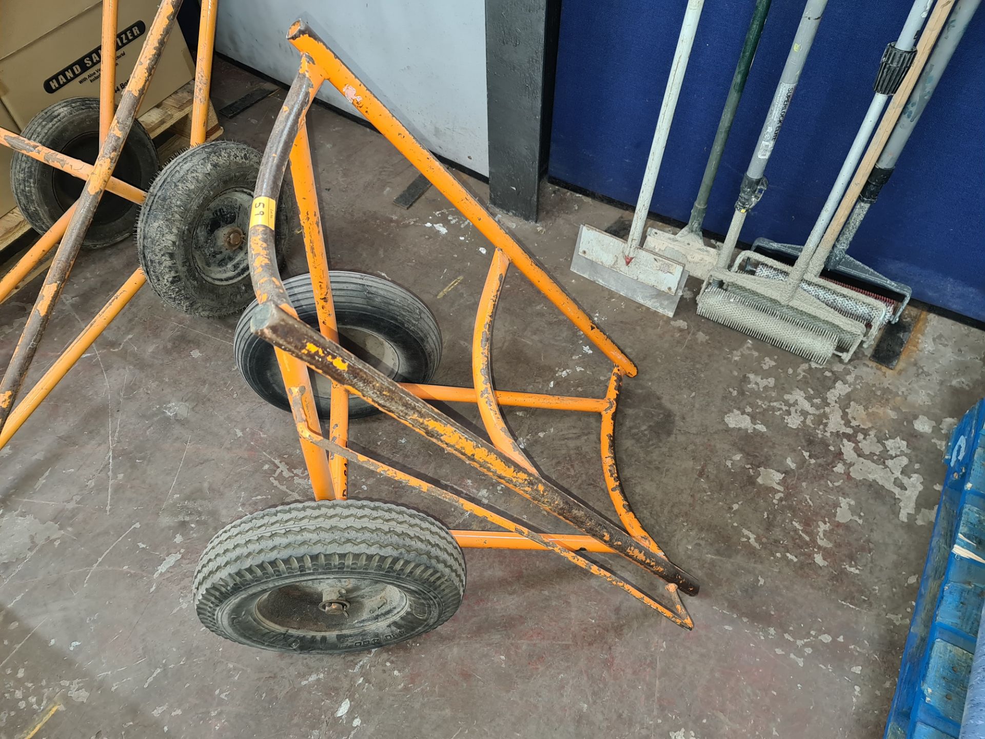 Trolley for use with handling rolls of carpet, vinyl flooring, artificial turf & similar