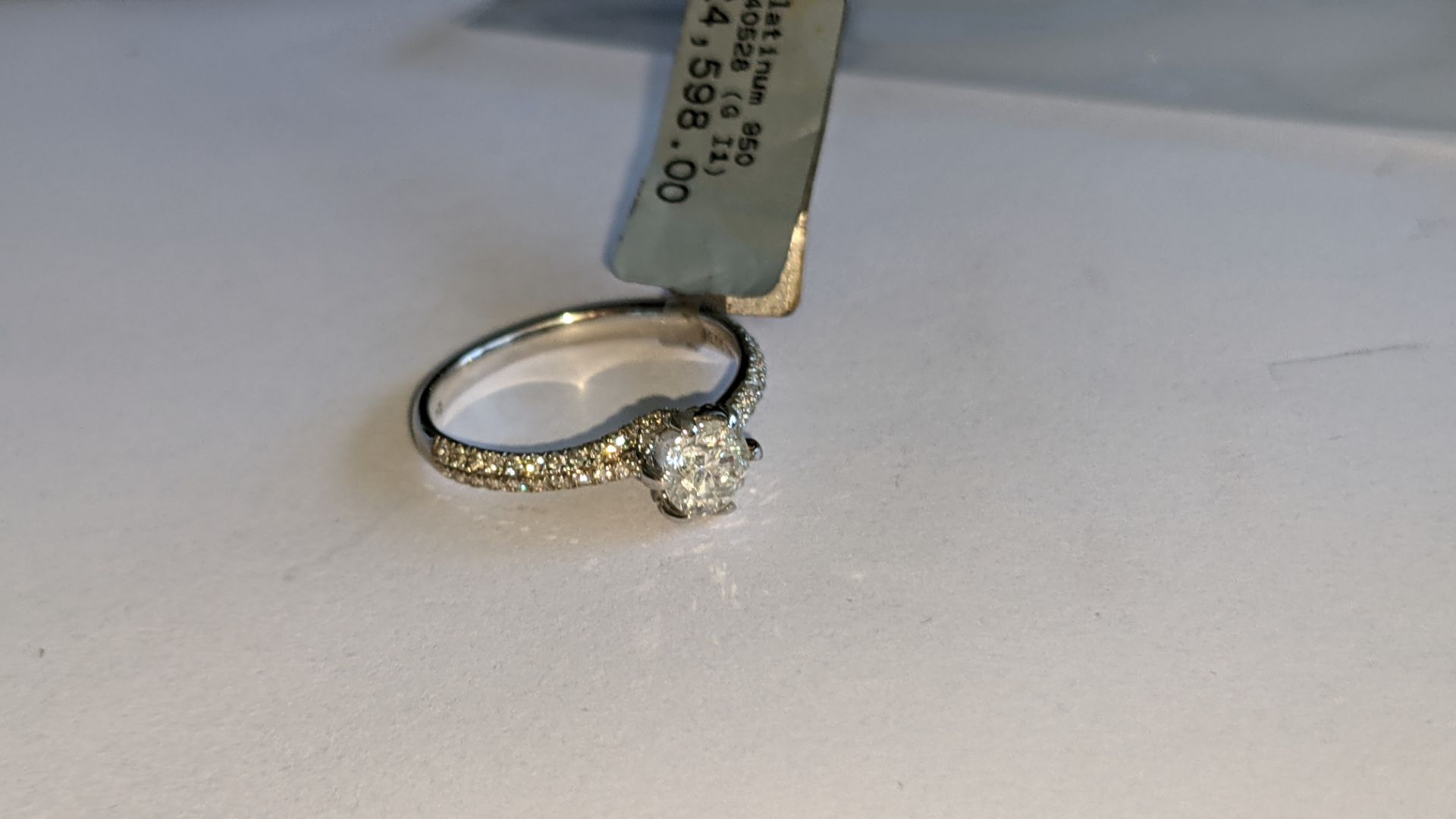 Platinum 950 diamond ring with 0.55ct central stone & 0.348ct of smaller stones on the shoulders. RR - Image 7 of 16