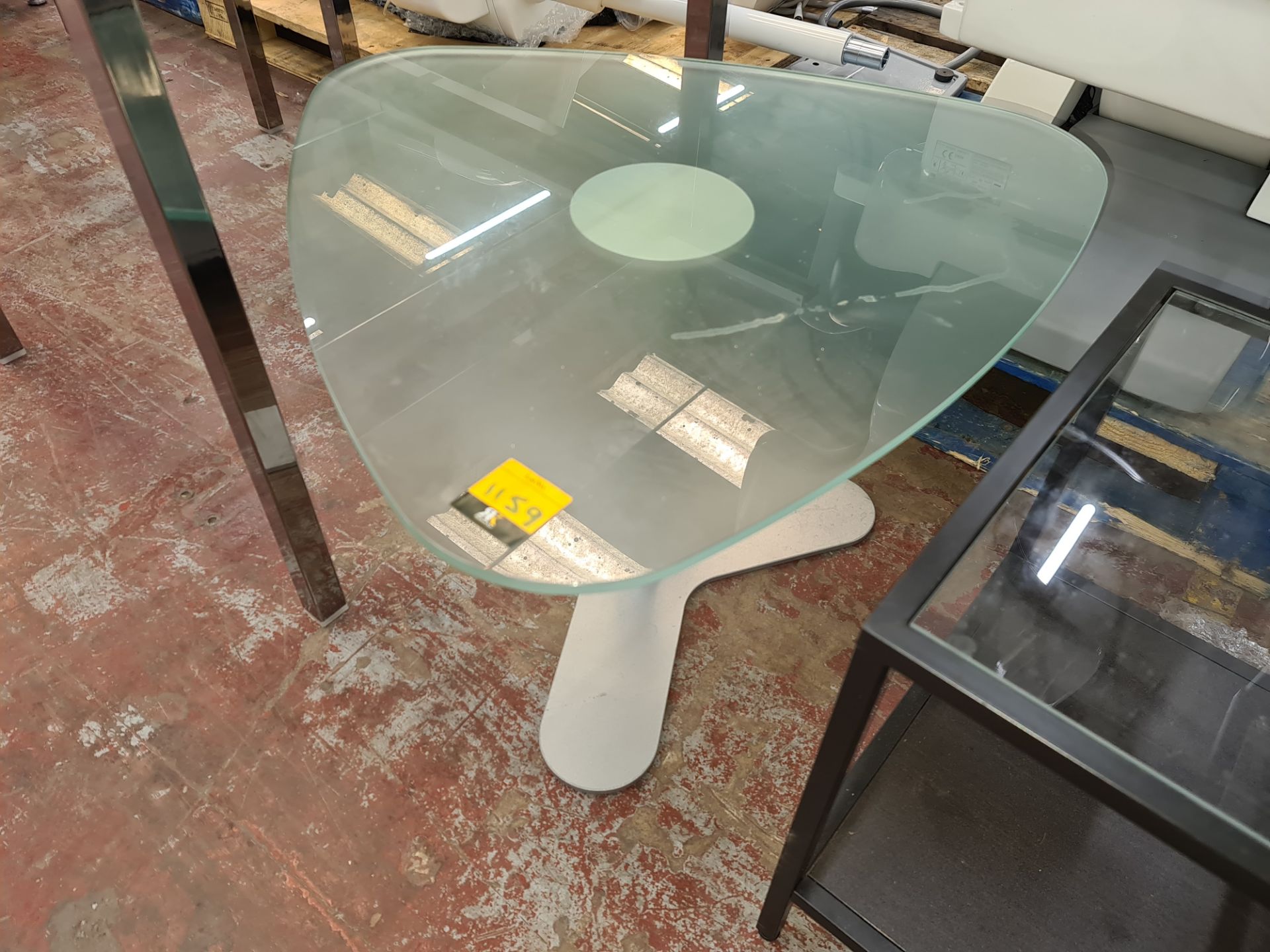 Unusually shaped frosted glass table on silver single pedestal base