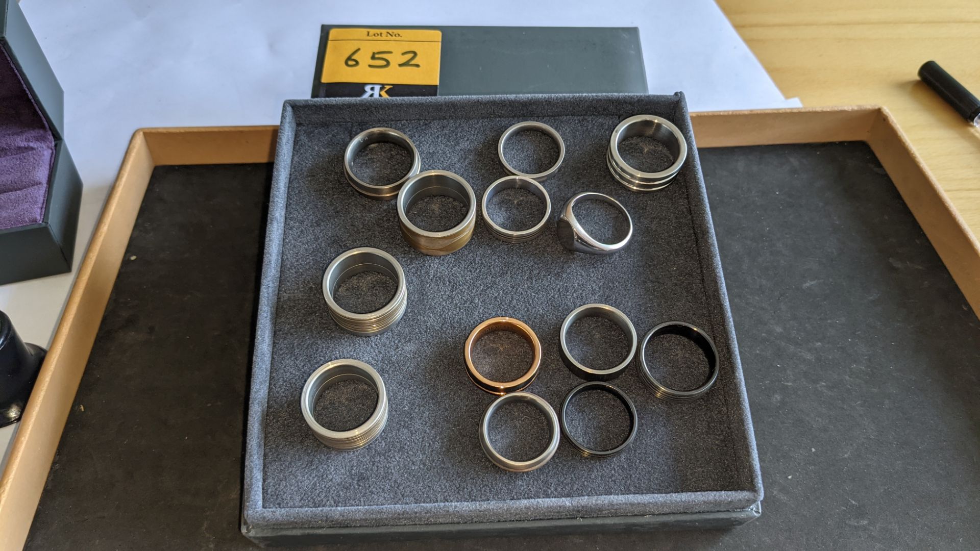 13 assorted men's rings. Understood to be made of a variety of materials including silver, stainless