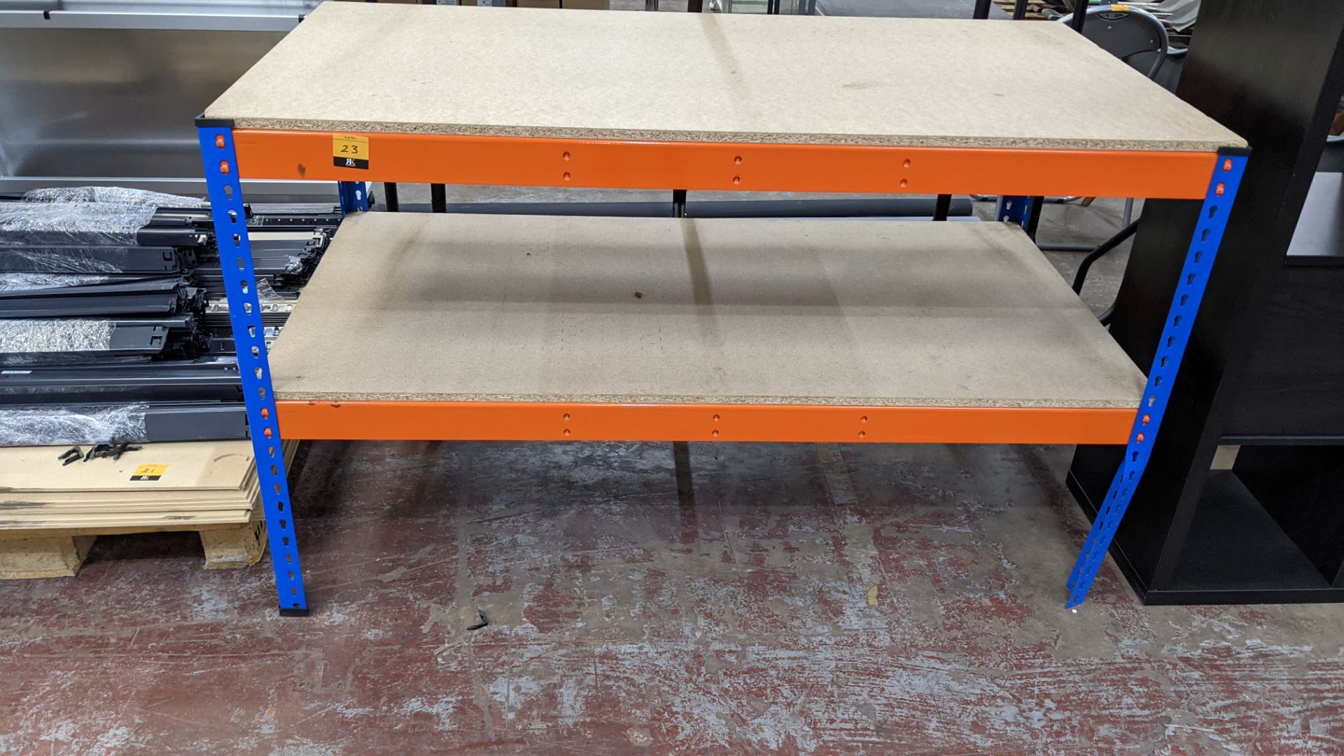 Workbench comprised of orange & blue bolt-free racking with 2 chipboard shelves