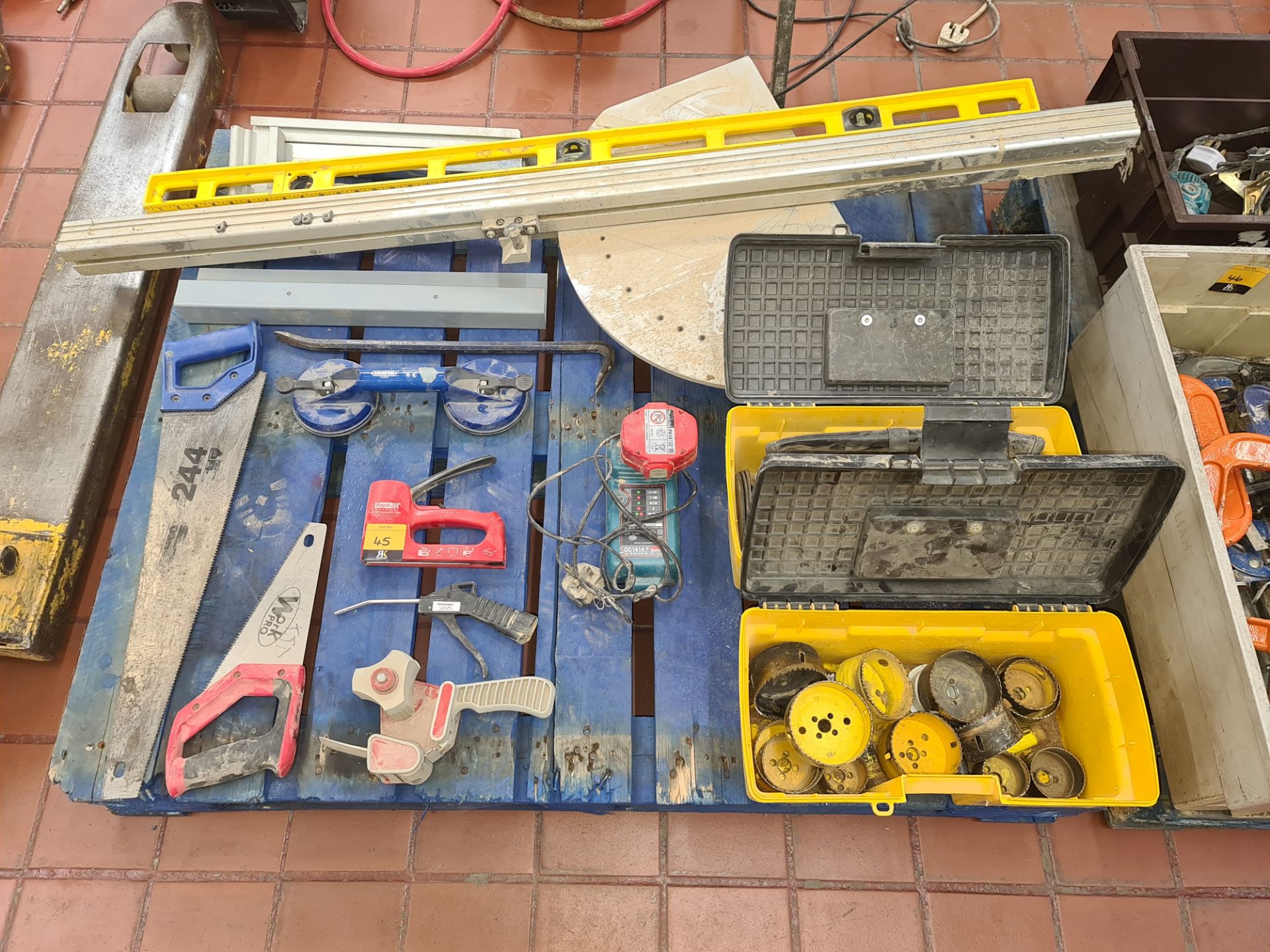 Contents of a pallet of miscellaneous items including hand tools, boring heads, handling equipment,