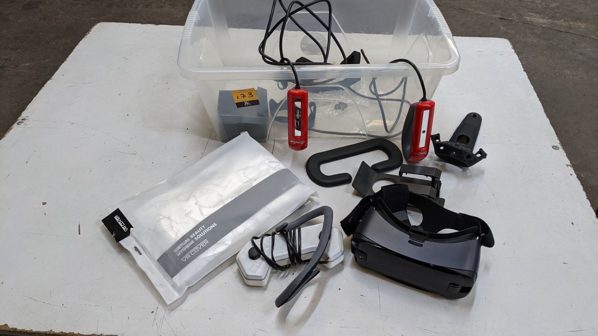 Contents of a crate of assorted virtual reality items including Samsung headset, assorted handles/co